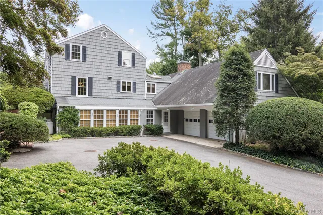 a front view of a house with a yard and porch
