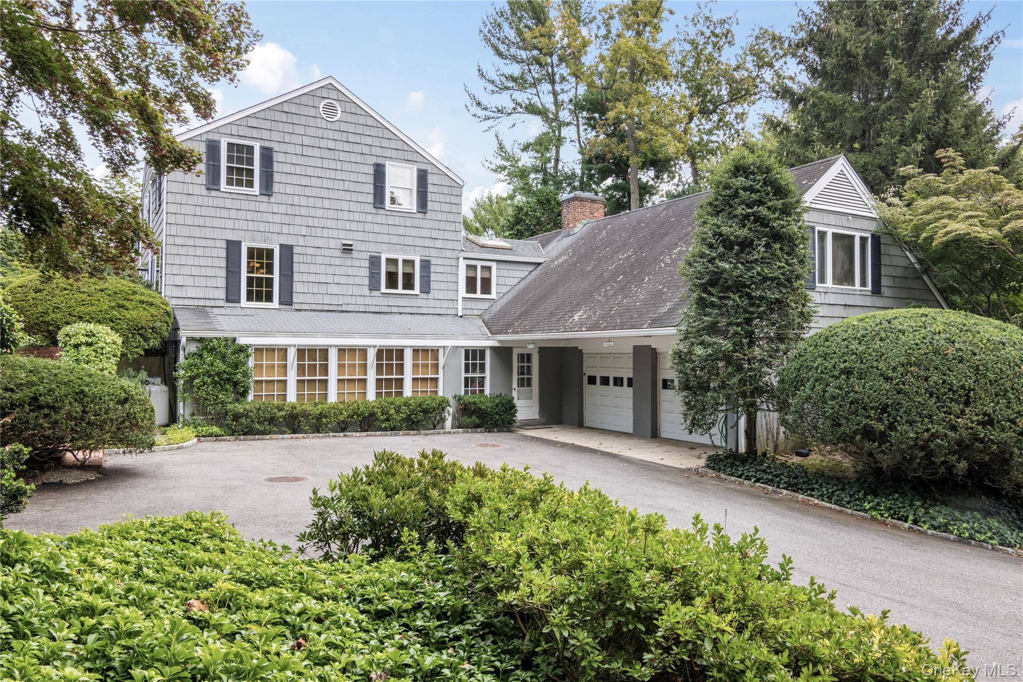 1276 Ridge Road Syosset, NY 11791 - Photo 2 of 30 a front view of a house with a yard and porch