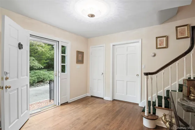 a view of entryway with wooden floor and front door