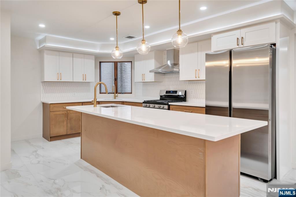 468 Morse Avenue Ridgefield, NJ 07657 - Photo 8 of 48 a kitchen that has a sink a center island stainless steel appliances and cabinets