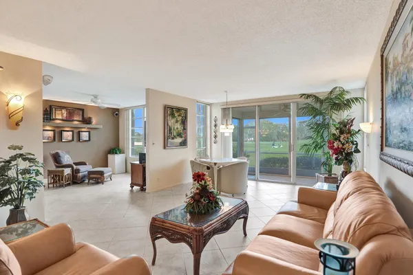 a living room with furniture and a potted plant