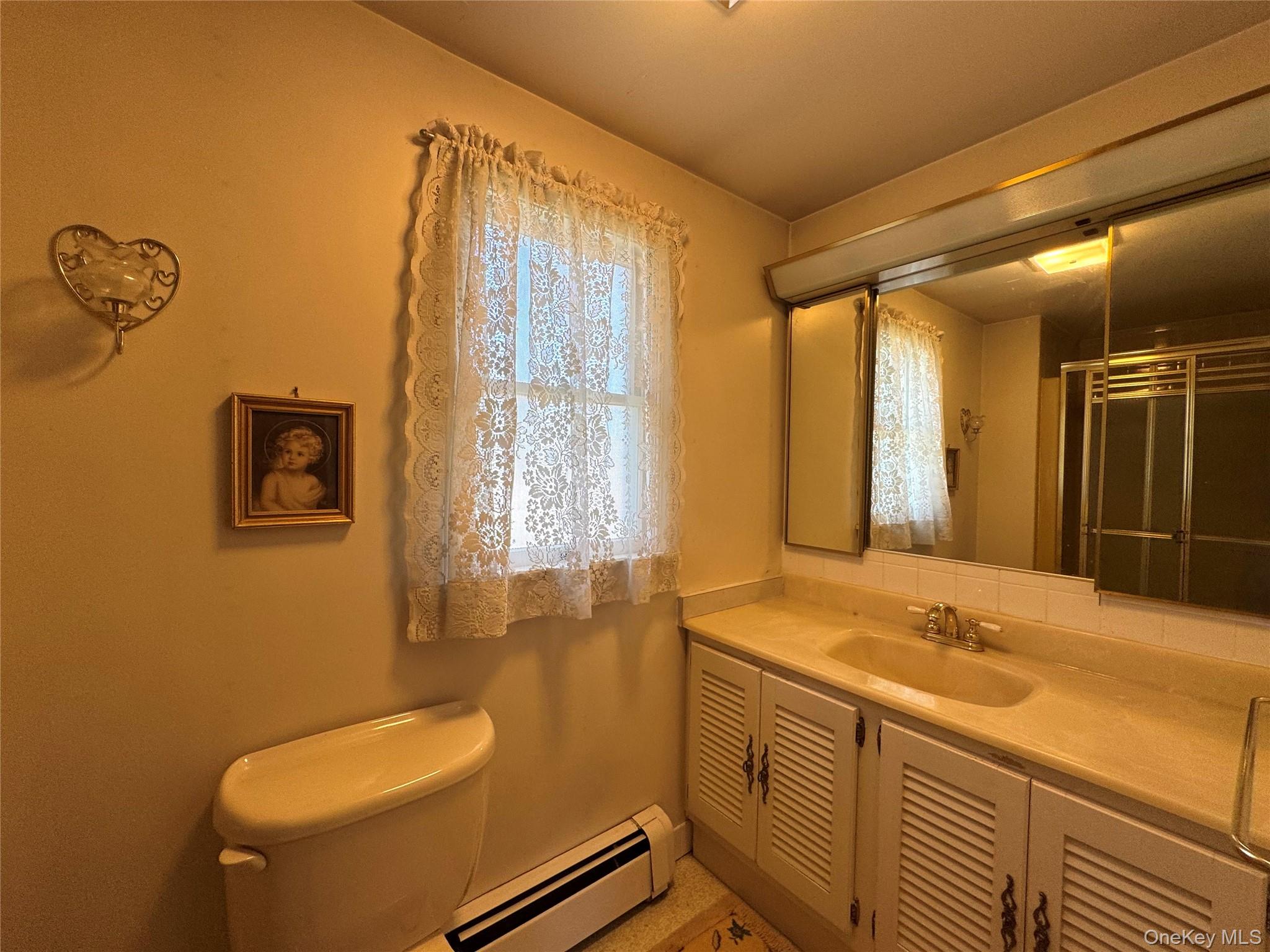 36 Jones Street Cairo, NY 12413 - Photo 18 of 32 a bathroom with a granite countertop sink and a mirror