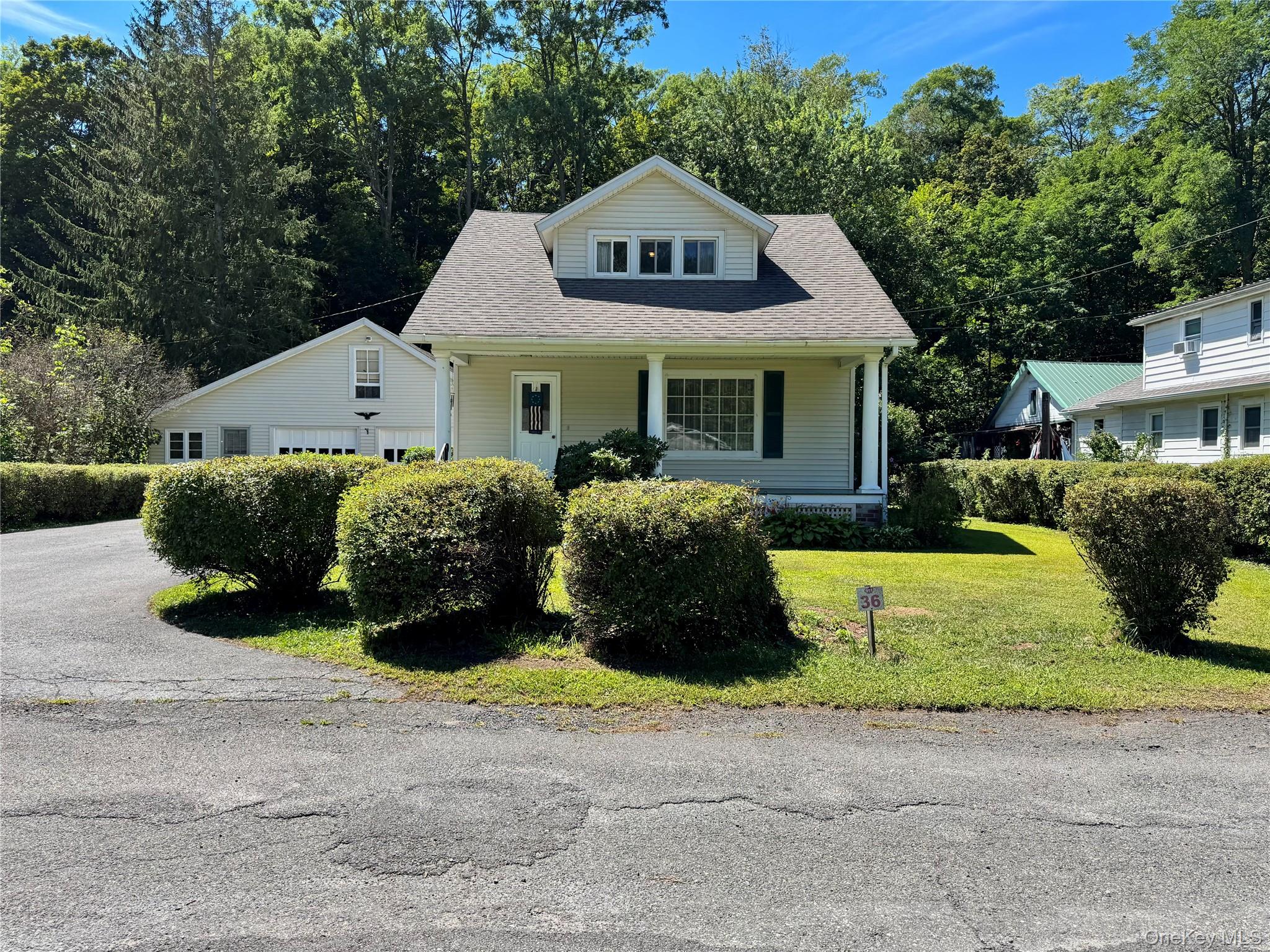 36 Jones Street Cairo, NY 12413 - Photo 2 of 32 a front view of a house with a yard and garage