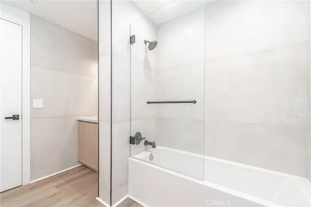 a white bath tub sitting next to a shower