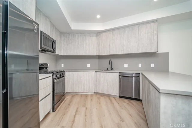 a kitchen with cabinets and stainless steel appliances