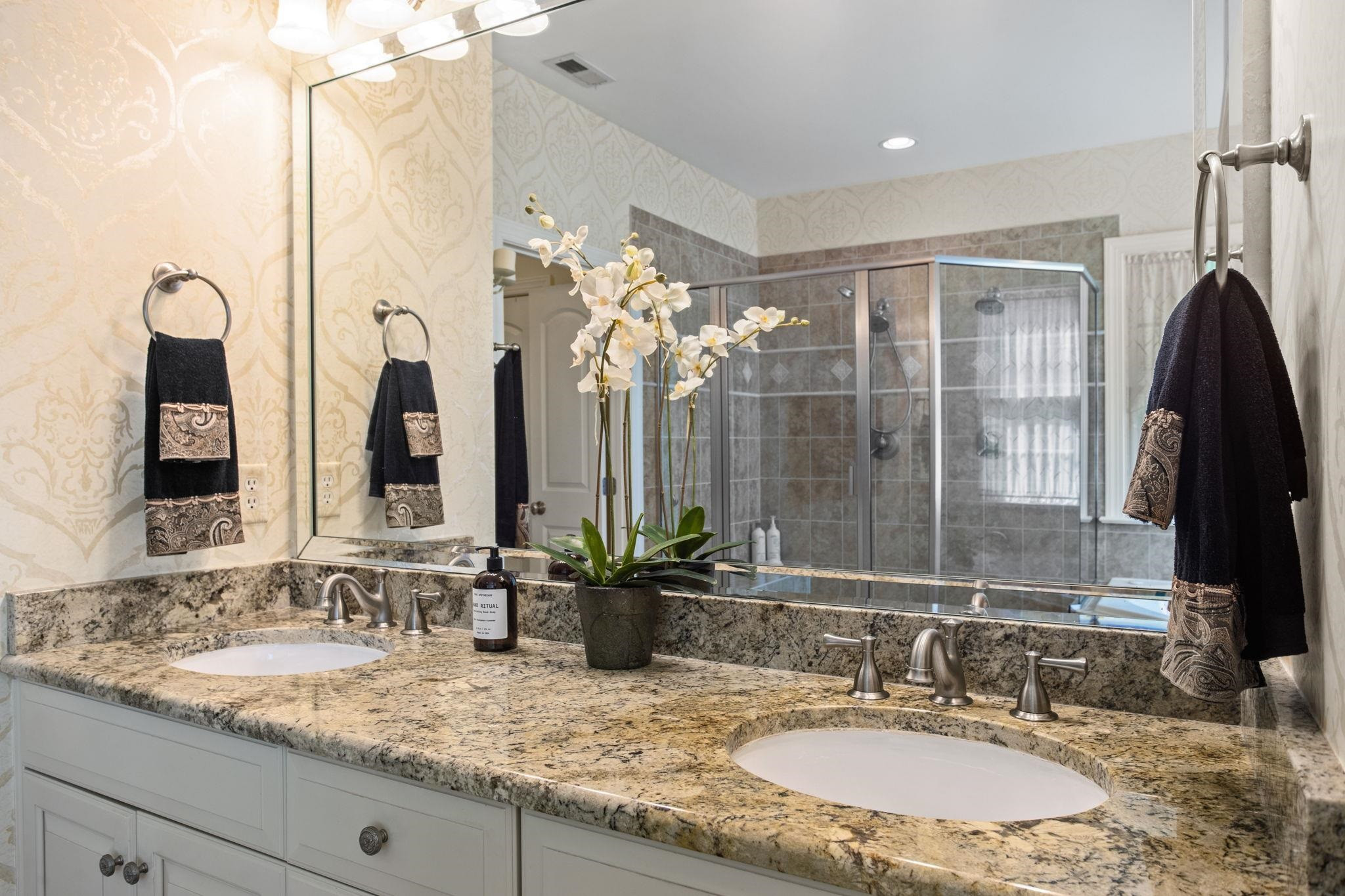 3223 Rain Forrest Way Raleigh, NC 27614 - Photo 28 of 71 a bathroom with a granite countertop sink and a mirror