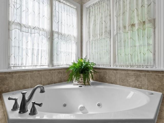 3223 Rain Forrest Way Raleigh, NC 27614 - Photo 29 of 71 a bath tub sitting in a bathroom next to a window