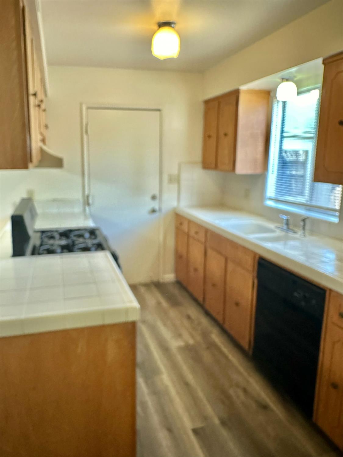 322 West Richert Avenue Clovis, CA 93612 - Photo 2 of 22 a kitchen with a sink stove and cabinets
