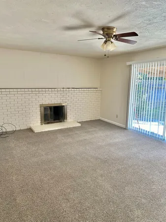 a view of an empty room with a fireplace