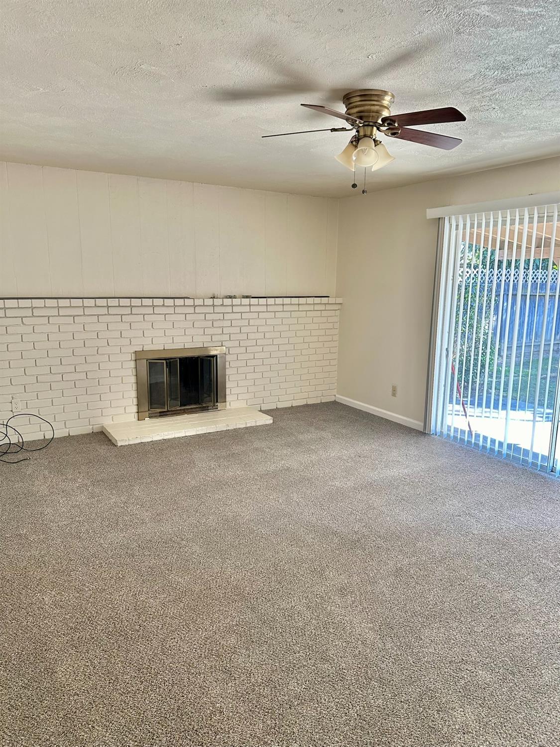 322 West Richert Avenue Clovis, CA 93612 - Photo 7 of 22 a view of an empty room with a fireplace