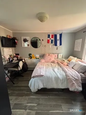 a bedroom with a bed and window