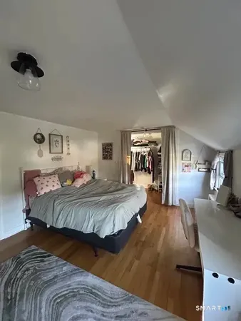 a bed room with a bed mirror and a night stand