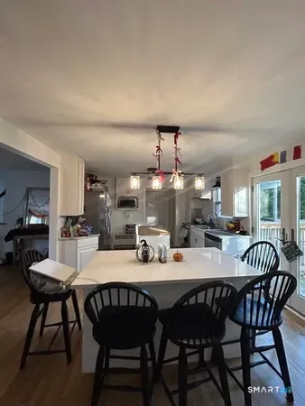 a dining room with a wooden table and chairs