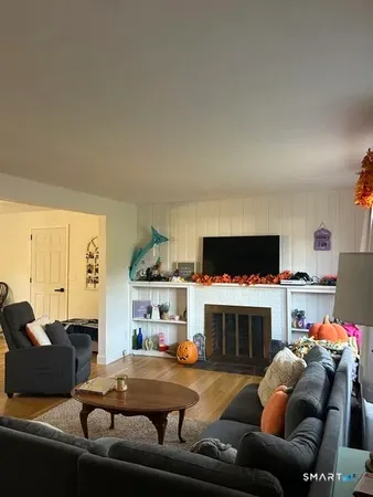 a living room with furniture a fireplace and a flat screen tv