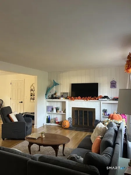107 Richfield Road Bridgeport, CT 06606 - Photo 23 of 24 a living room with furniture a fireplace and a flat screen tv