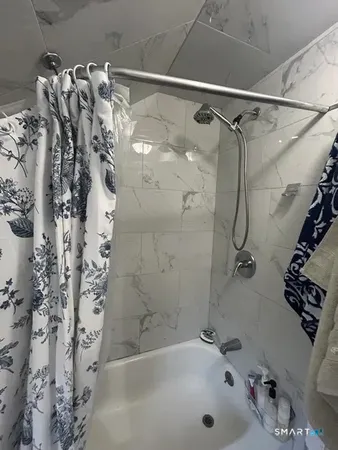 a bathroom with a bathtub and shower