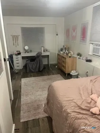a bedroom with a bed a couch and dresser