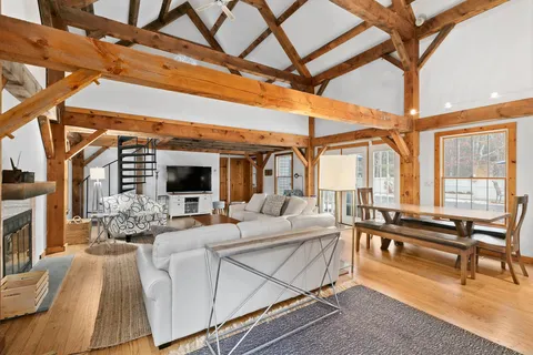 a living room with furniture a fireplace and city view