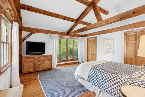 a bedroom with a bed and a flat screen tv