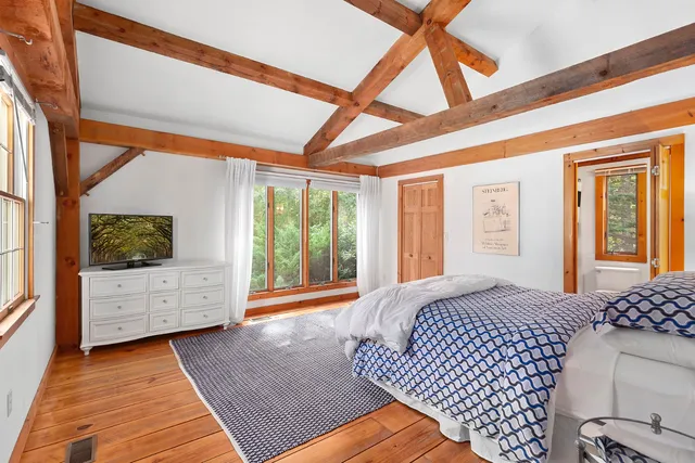 a view of bedroom with furniture flat screen tv and floor to ceiling window