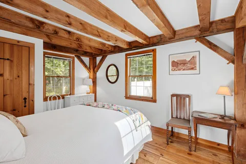 a bed sitting in a bedroom next to a window