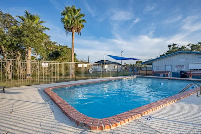 a view of a swimming pool with a patio