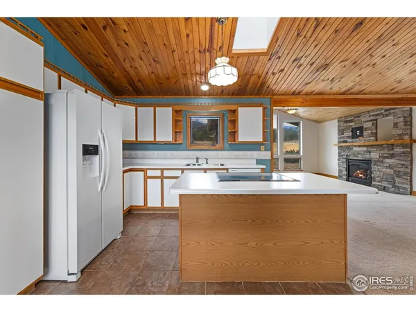 a large kitchen with stainless steel appliances granite countertop a sink a stove and a refrigerator