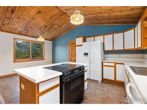 a kitchen that has a fridge and a stove