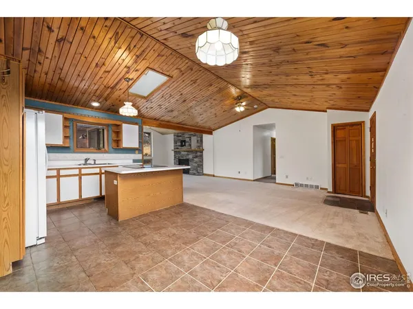 a large kitchen with stainless steel appliances granite countertop a stove a sink dishwasher and cabinets with wooden floor