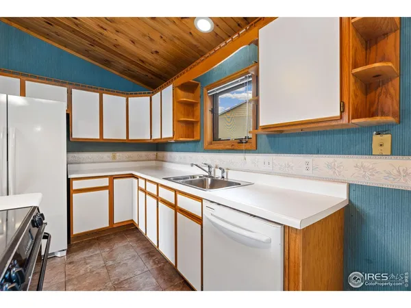 a kitchen with stainless steel appliances granite countertop a sink and dishwasher a stove with wooden floor