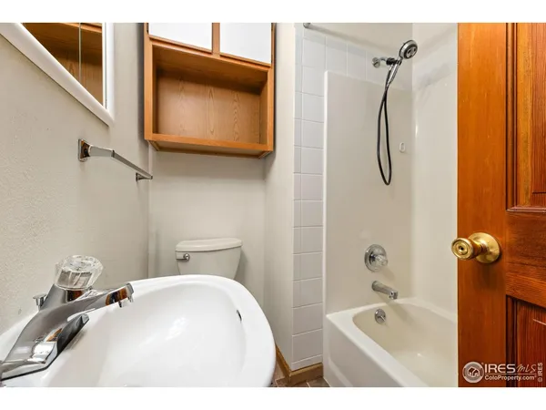 a bathroom with a tub a sink and a shower