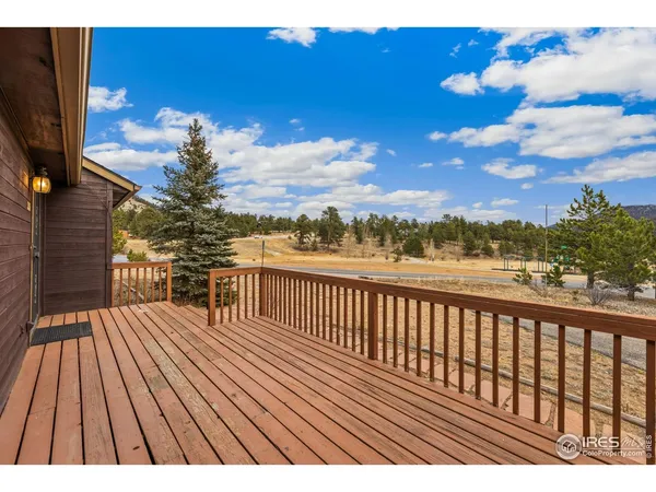 a view of balcony with wooden floor and outdoor seating