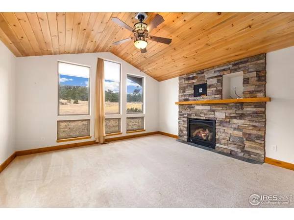 a view of an empty room with a fireplace
