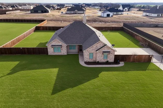 an aerial view of a house with swimming pool garden and lake view
