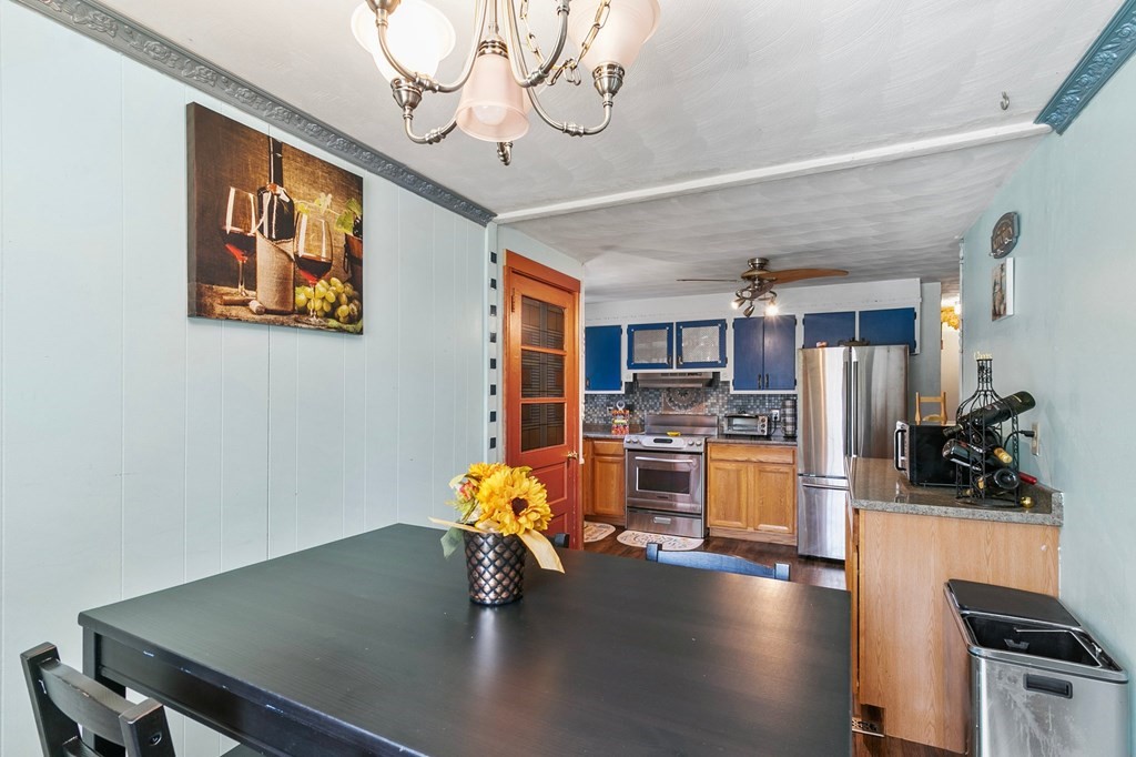 90 Newhouse Street Springfield, MA 01118 - Photo 15 of 36 a kitchen with a table chairs refrigerator and a sink