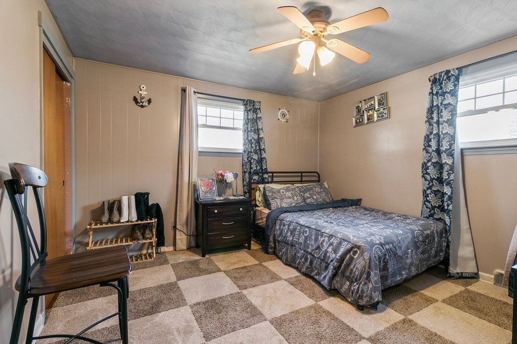 90 Newhouse Street Springfield, MA 01118 - Photo 22 of 36 a bedroom with a bed and a chandelier