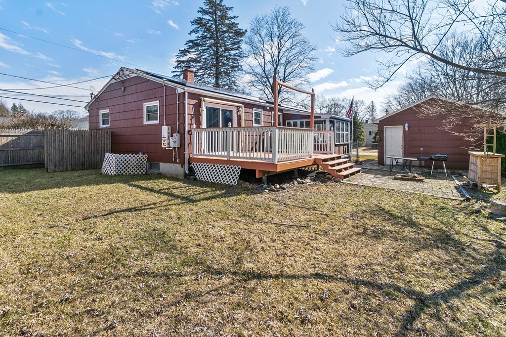 90 Newhouse Street Springfield, MA 01118 - Photo 27 of 36 a backyard of a house with yard and wooden fence