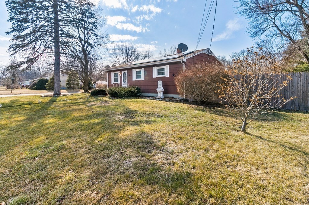 90 Newhouse Street Springfield, MA 01118 - Photo 3 of 36 a front view of a house with a yard