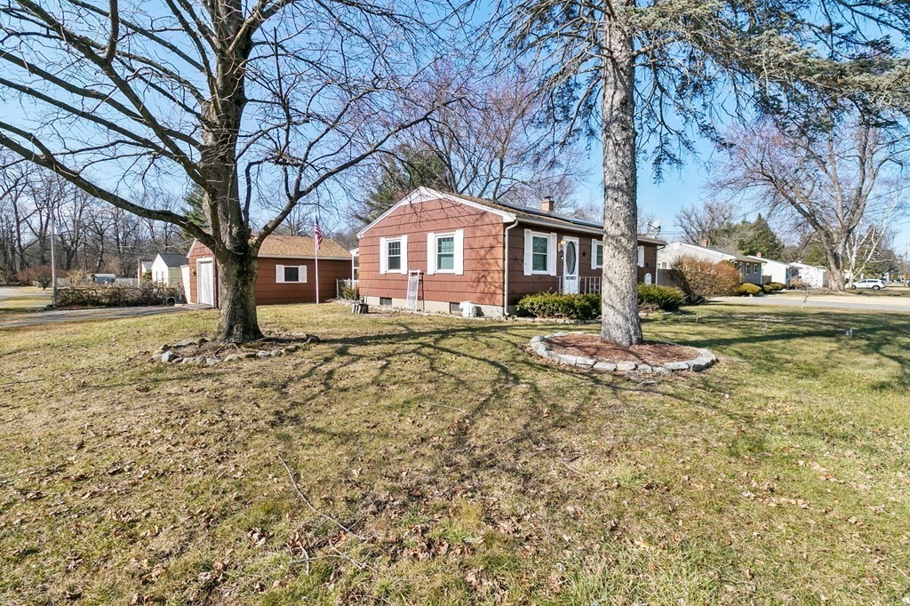 90 Newhouse Street Springfield, MA 01118 - Photo 4 of 36 a front view of a house with a yard