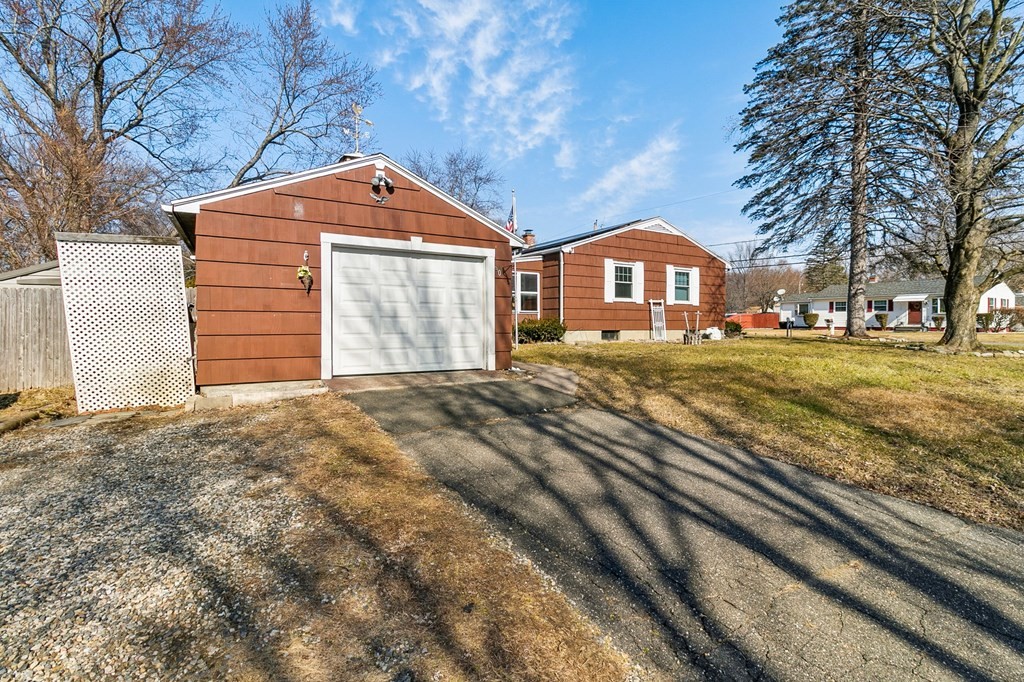 90 Newhouse Street Springfield, MA 01118 - Photo 6 of 36 a front view of a house with a yard