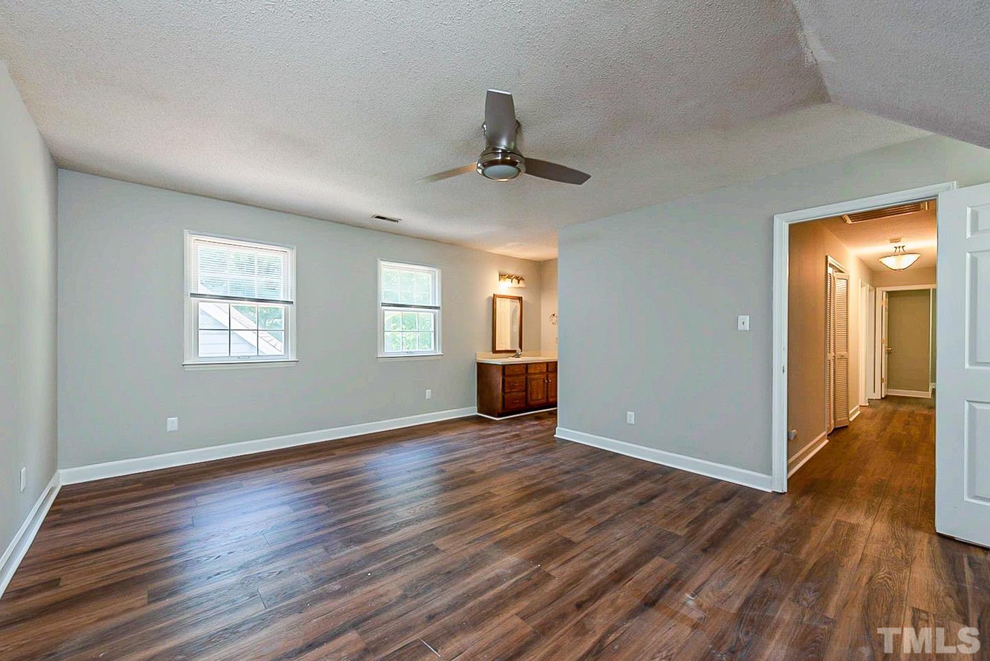 4714 Highgate Drive Durham, NC 27713 - Photo 11 of 22 a view of an empty room with window and wooden floor