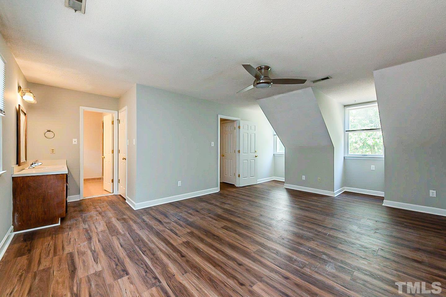 4714 Highgate Drive Durham, NC 27713 - Photo 13 of 22 an empty room with wooden floor and windows
