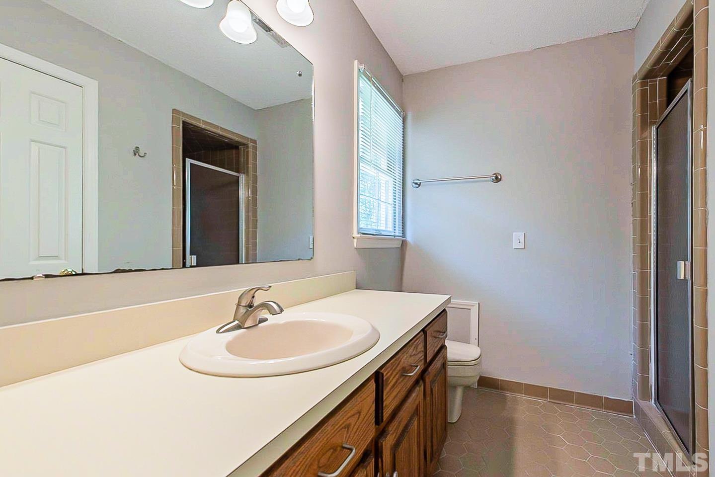 4714 Highgate Drive Durham, NC 27713 - Photo 19 of 22 a bathroom with a sink and a mirror