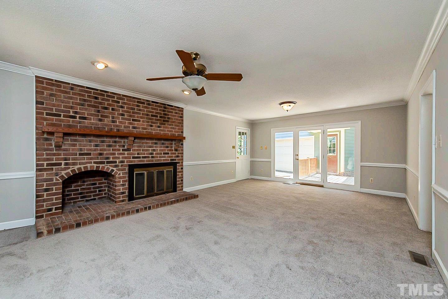 4714 Highgate Drive Durham, NC 27713 - Photo 3 of 22 a view of an empty room with a fireplace and a window