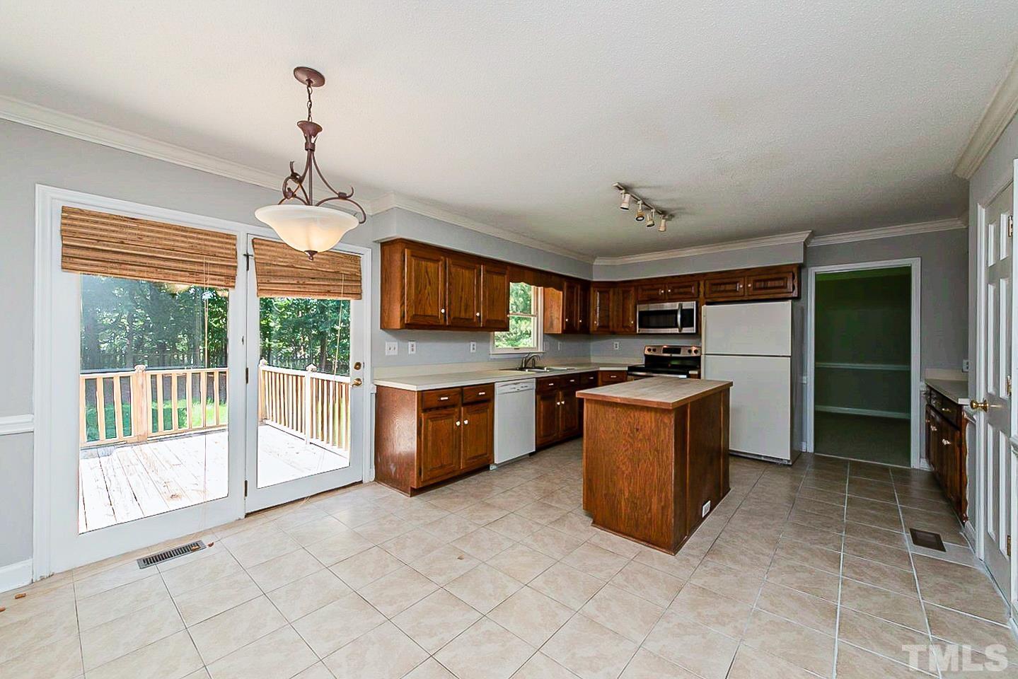 4714 Highgate Drive Durham, NC 27713 - Photo 5 of 22 a large kitchen with stainless steel appliances granite countertop a stove top oven a sink dishwasher a refrigerator and a fireplace