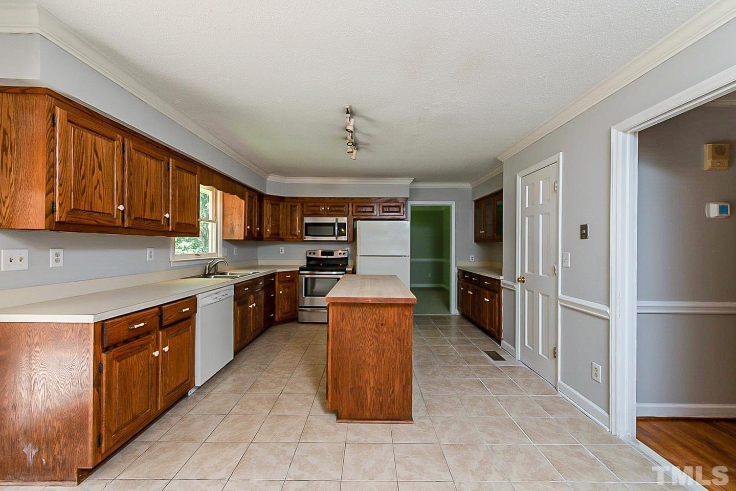 4714 Highgate Drive Durham, NC 27713 - Photo 6 of 22 a large kitchen with stainless steel appliances granite countertop a stove refrigerator and a kitchen island