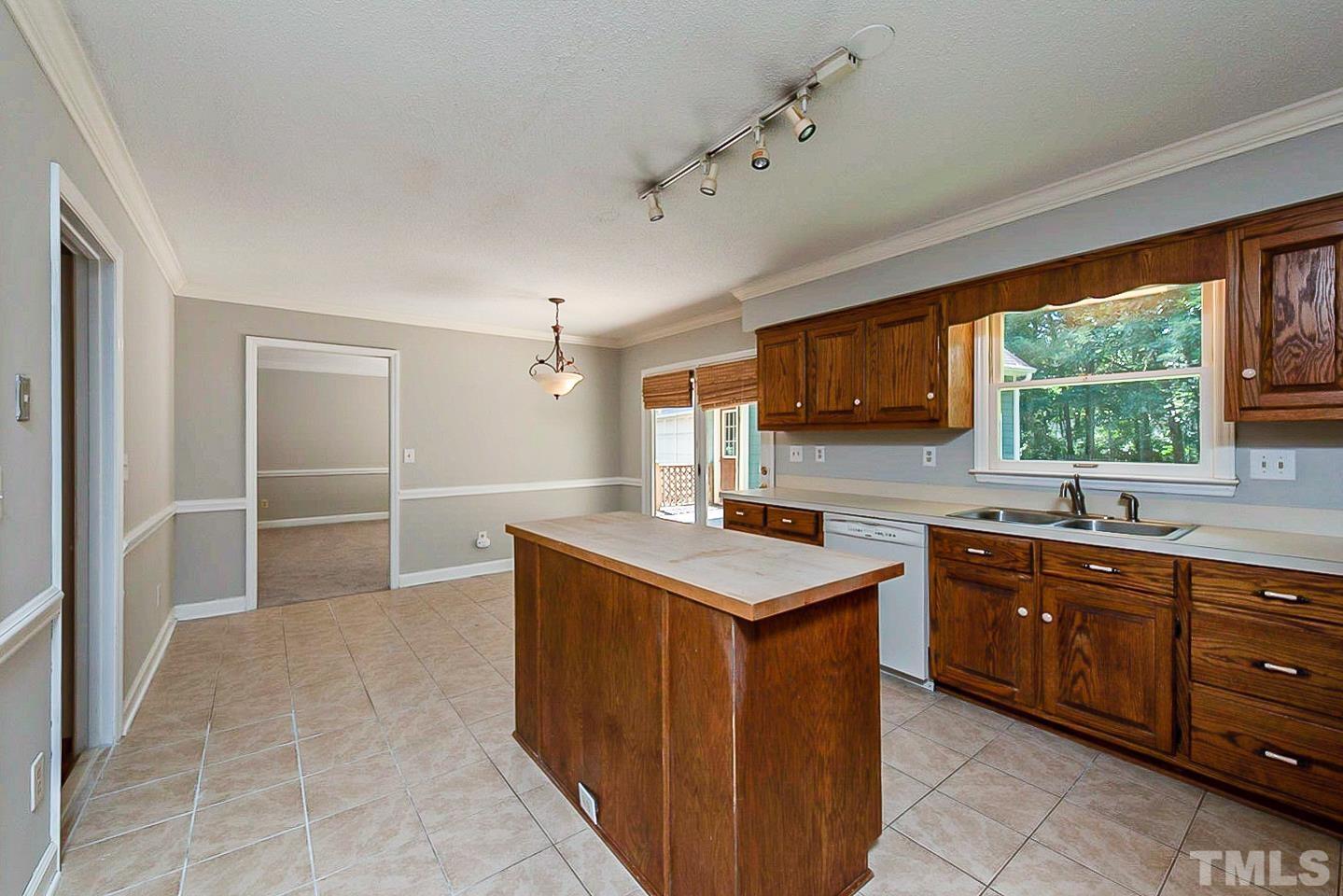 4714 Highgate Drive Durham, NC 27713 - Photo 7 of 22 a kitchen with a sink a stove and cabinets