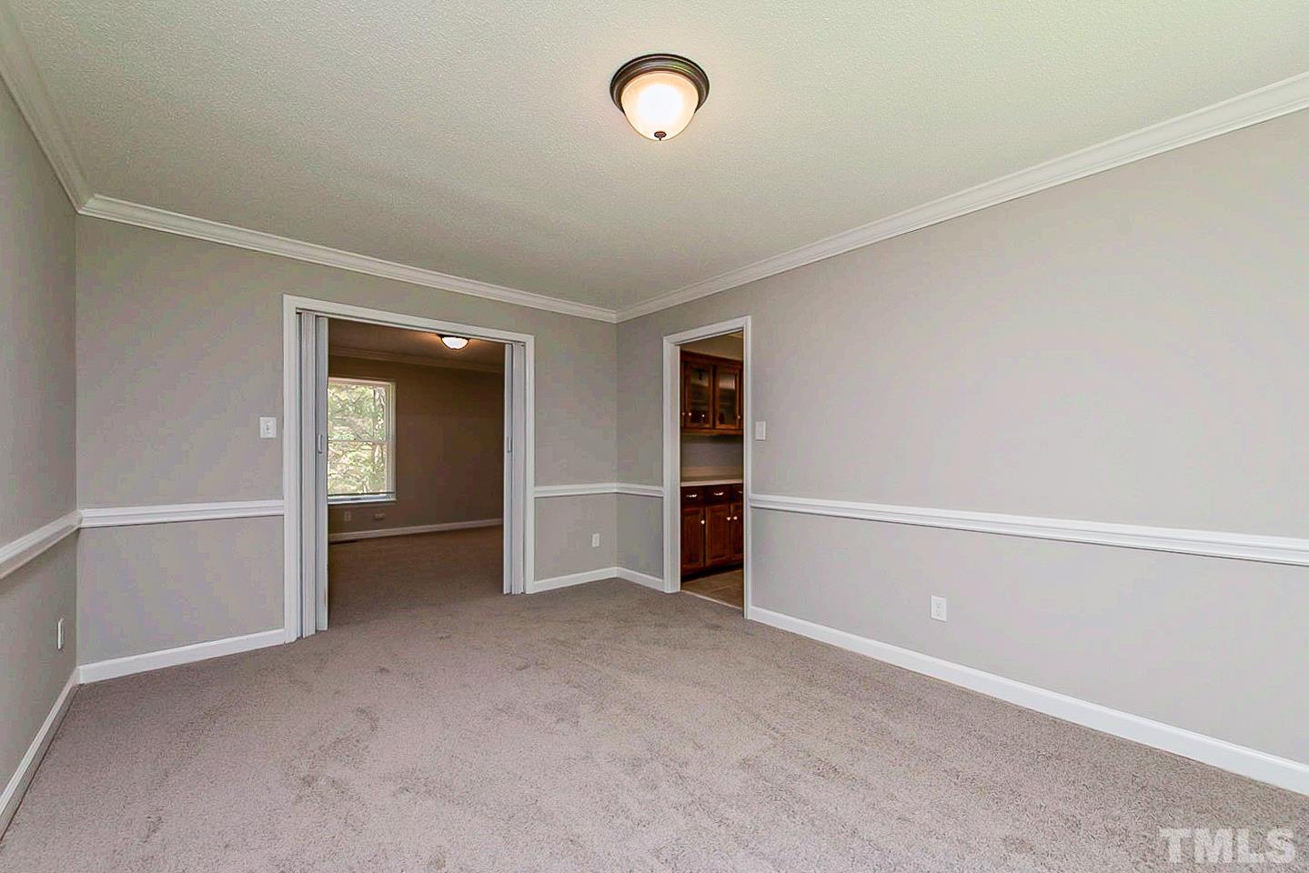 4714 Highgate Drive Durham, NC 27713 - Photo 9 of 22 an empty room with closet and windows