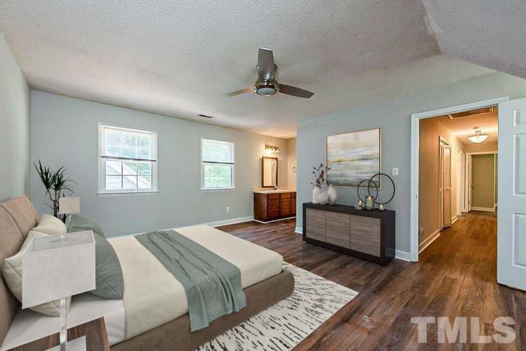 4714 Highgate Drive Durham, NC 27713 - Photo 10 of 22 a bedroom with a bed and wooden floor