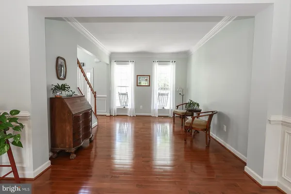 a room with wooden floor and gym equipment
